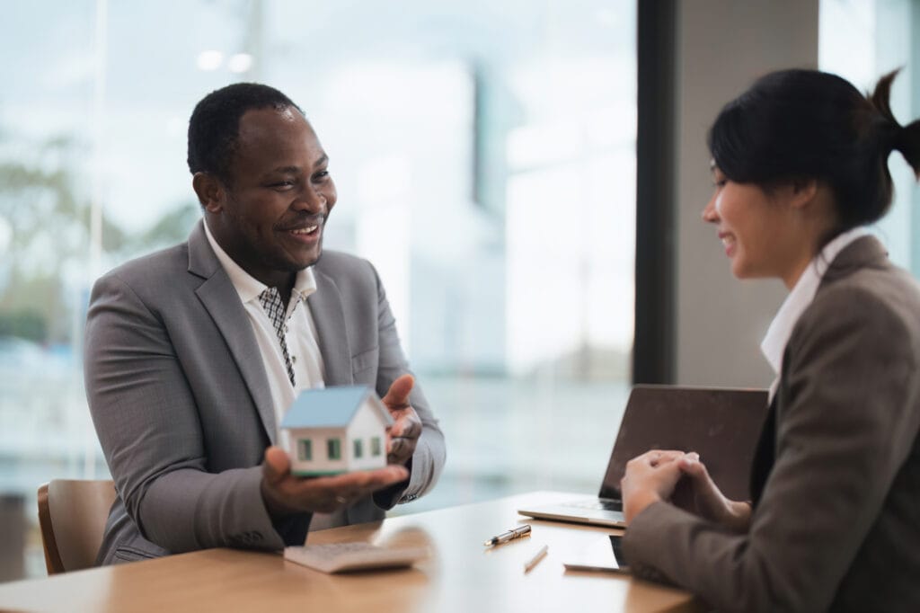 african american real estate agent showing house to his clients after contract signing, concept for real estate, moving house or renting property with diversity ethnicity