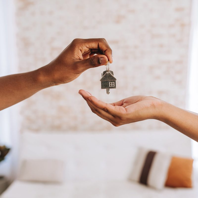 real estate agent giving a man the keys to his new home